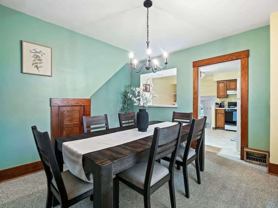 Stylish dining room with seating for six, open to kitchen—great for shared meals ✨