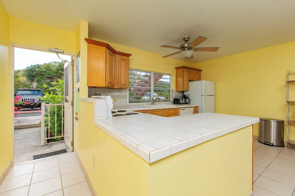 Bright, functional kitchen with full-size appliances and breakfast bar.