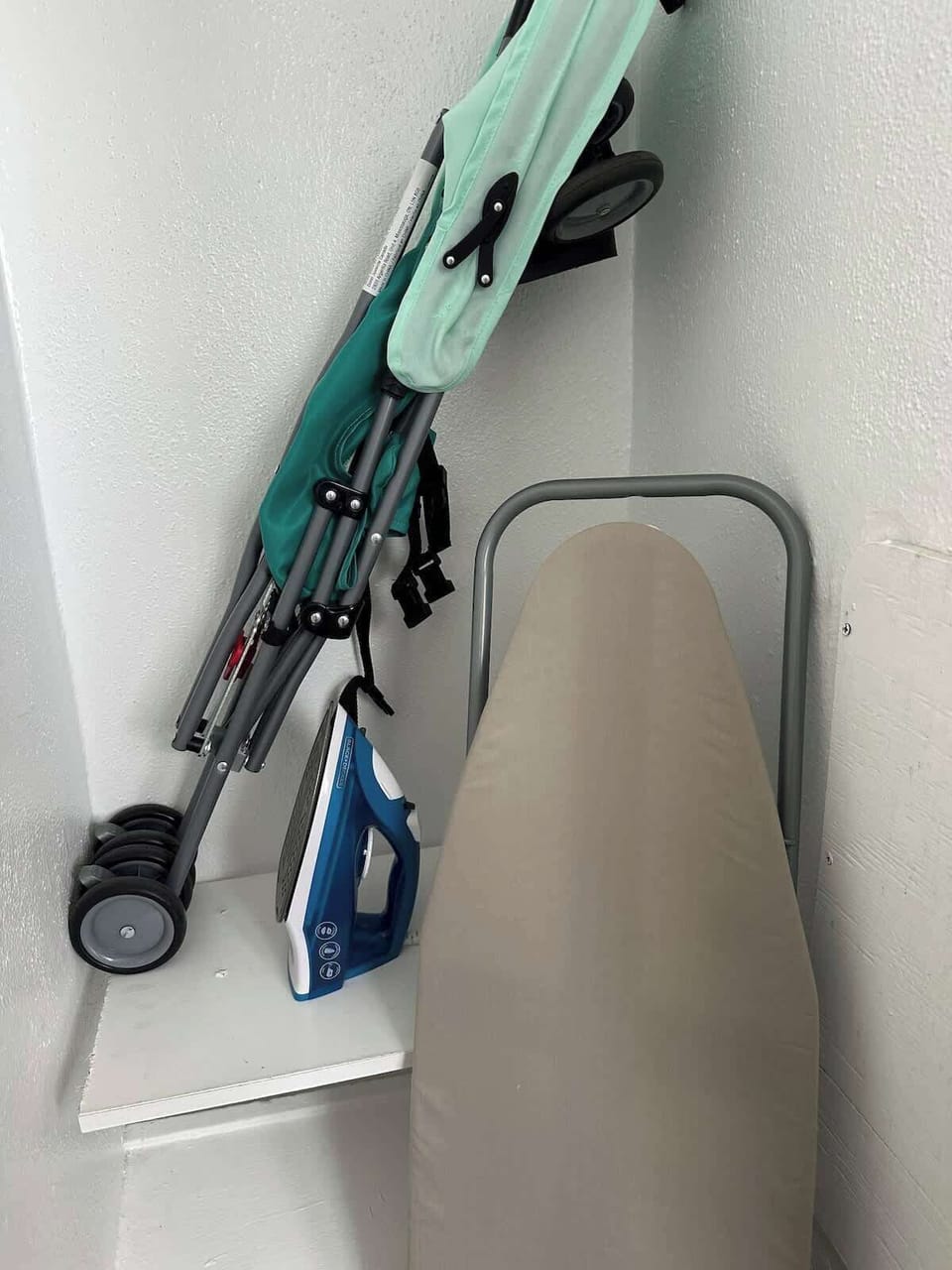 Bathroom essentials including iron and ironing board