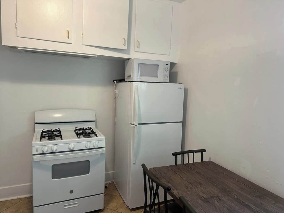 Kitchen area with stove, fridge, and basic amenities