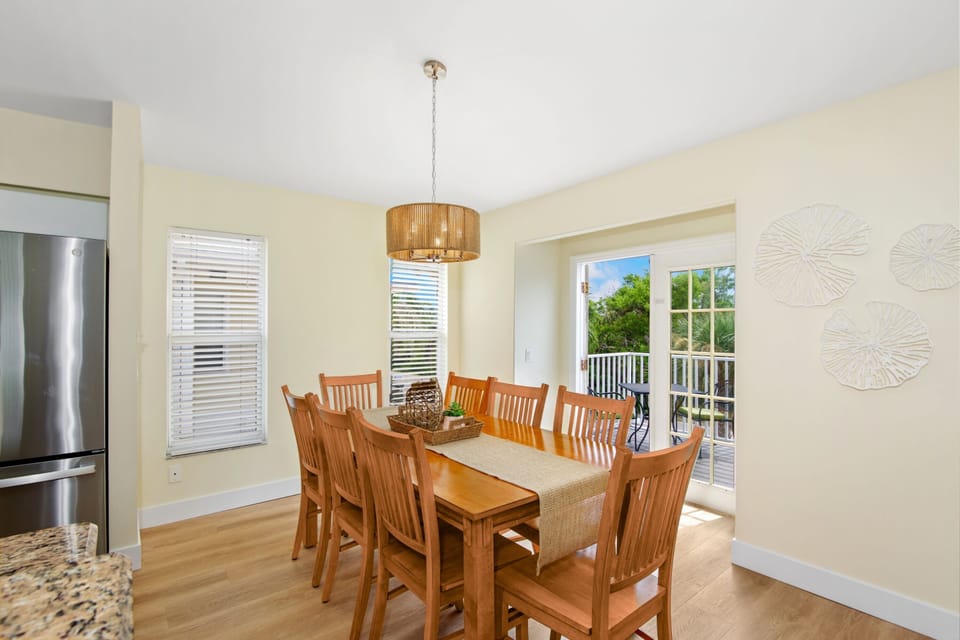 Dining set seats 8 and goes out to balcony