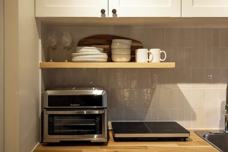 Compact yet fully equipped kitchenette—everything you need for quick meals and effortless stays.