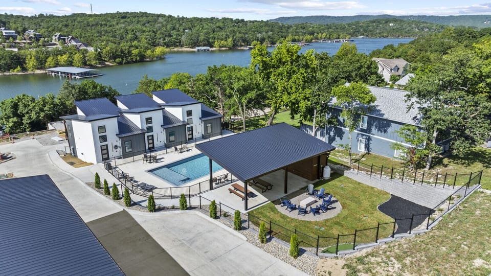 Resort-style amenities with pool, covered pavilion, and firepit — all just steps from the lake.