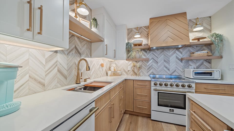 Updated well-stocked kitchen with touch sink.