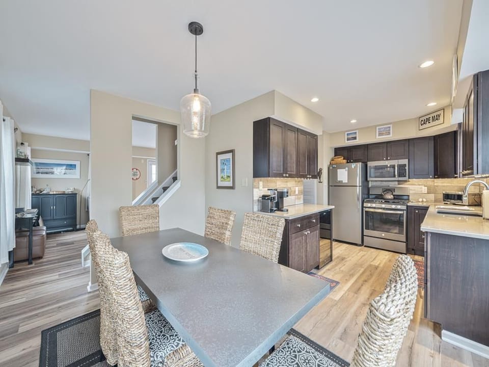 Modern open kitchen with stainless steel appliances and island seating for casual dining.