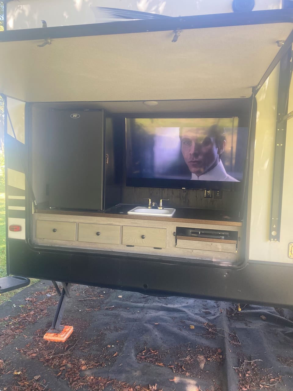 50 inch TV for outdoor viewing.  Mini fridge for beverages.