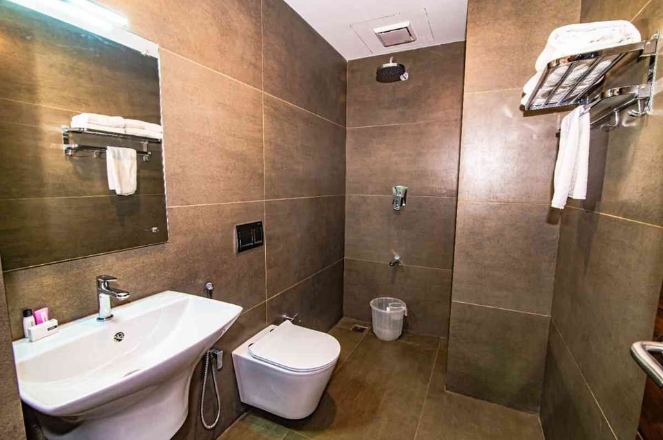 Premium Suite AC | Bathroom | Shower, towels, soap, shampoo