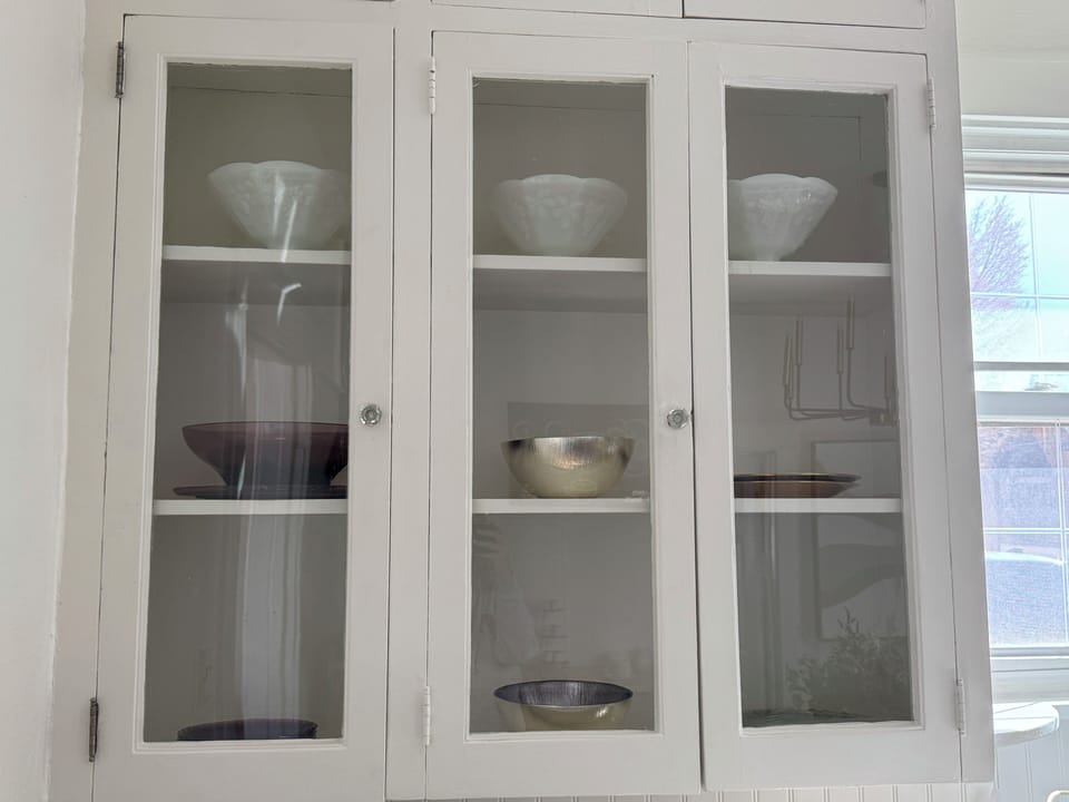 Elegant charm in every detail!  Period upper cabinets fully stocked. 
