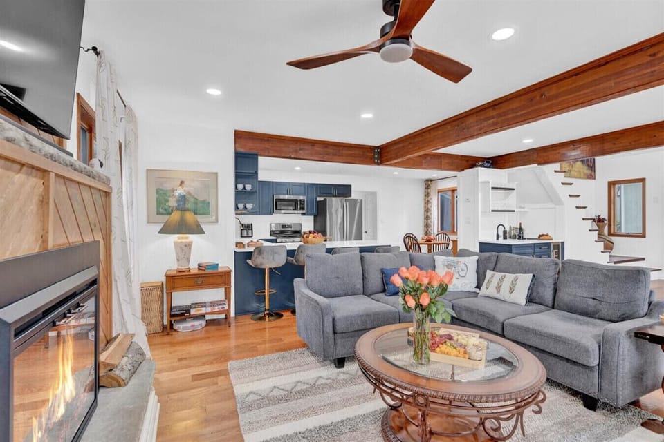 Stay comfortable year-round with a cozy fireplace and refreshing ceiling fan in the living room.