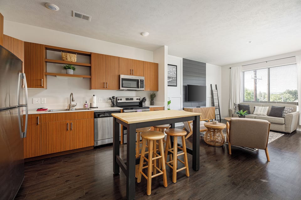 Open kitchen & living space w/ island seating & seamless flow for gathering