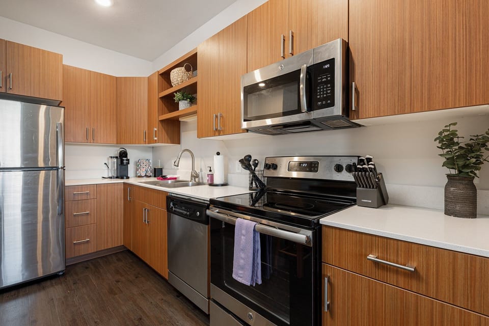 Modern kitchen w/ stainless steel appliances & generous counter space