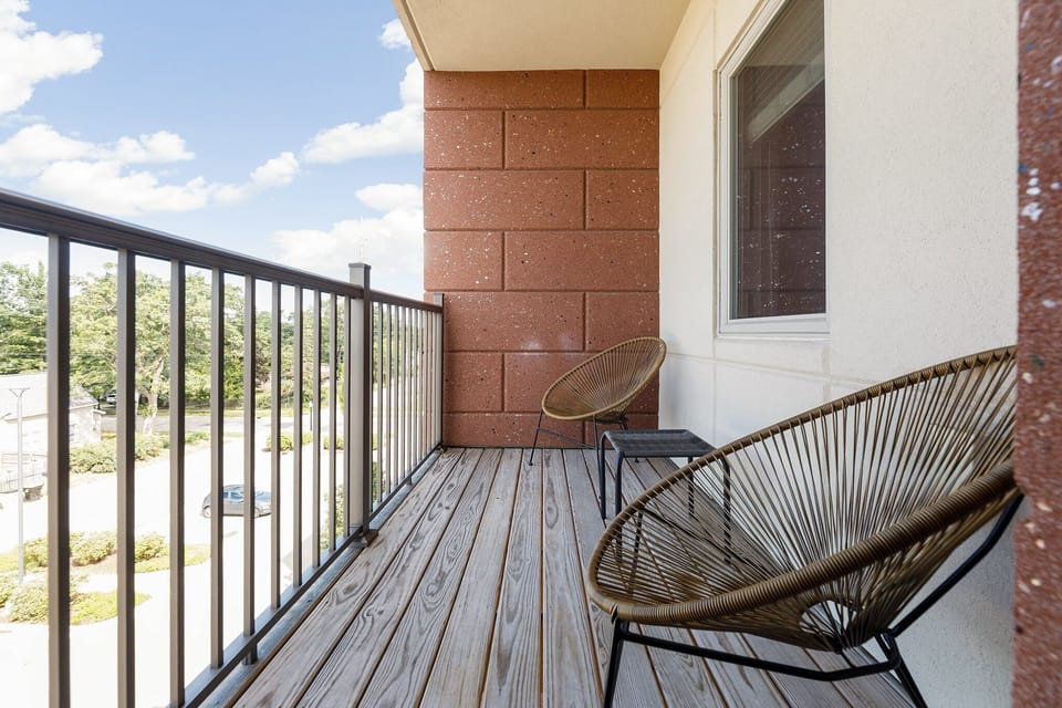 Private balcony w/ woven chair & railing views—perfect for quiet moments outside