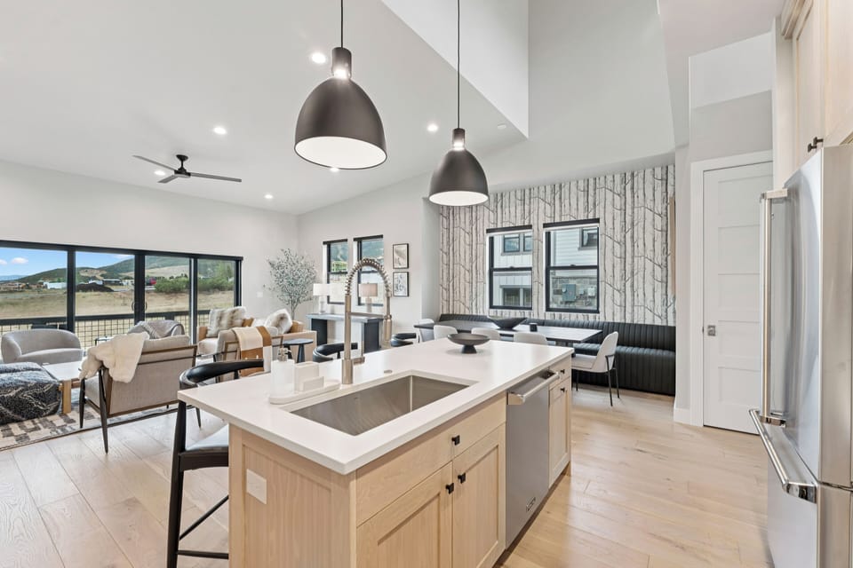 Bright kitchen with wood island, pendant lighting, and open-concept design.