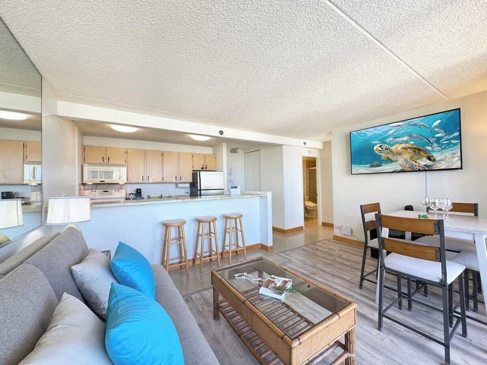 Entertain and unwind in this open-concept living space, featuring a dining area, breakfast bar, and comfortable seating for everyone.