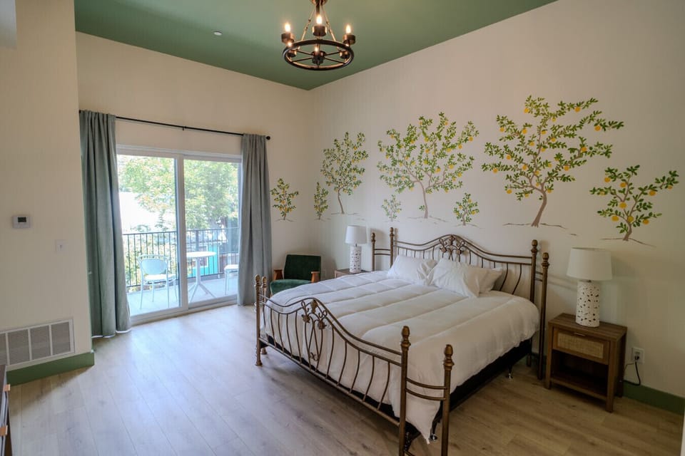 Bright and airy king room with private balcony and cheerful mural accents