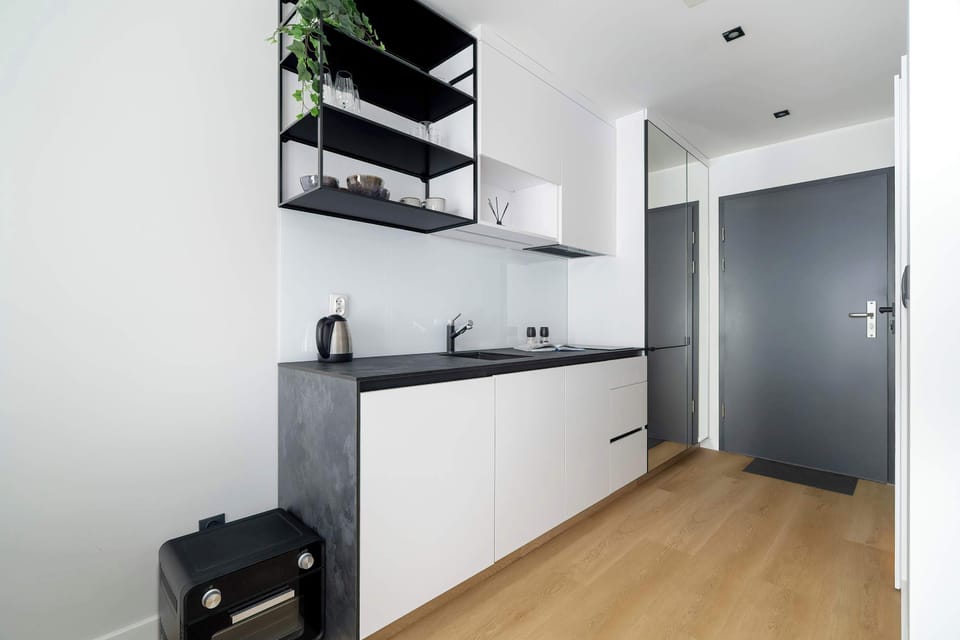 Kitchenette with plenty of kitchen utensils and dishes.