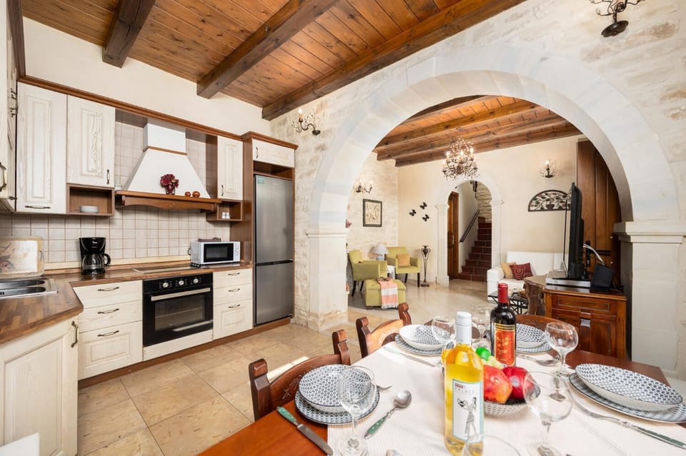 Unit 2 - open-plan living room with sofa, dining area, kitchen, ornamental fireplace, A/C, WiFi internet, and satellite TV