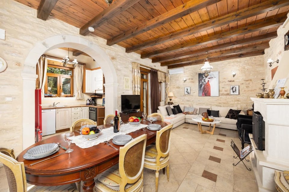 Unit 1 - open-plan living room with sofa, dining area, kitchen, ornamental fireplace, A/C, WiFi internet, and satellite TV