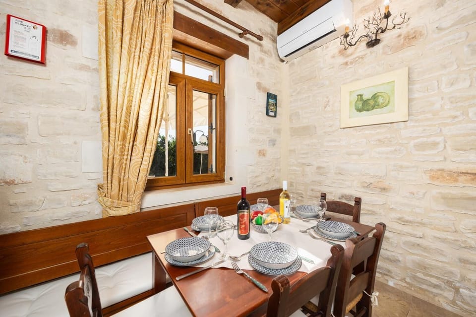 Unit 2 - open-plan living room with sofa, dining area, kitchen, ornamental fireplace, A/C, WiFi internet, and satellite TV