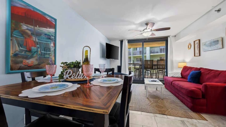 {DINING} Share fall feasts or game nights in the open dining & living area. Cozy seating, bright decor, and balcony views make it the heart of your fall getaway.