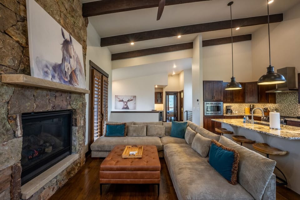 Living area featuring a gas fireplace, smart TV, & a spacious sectional