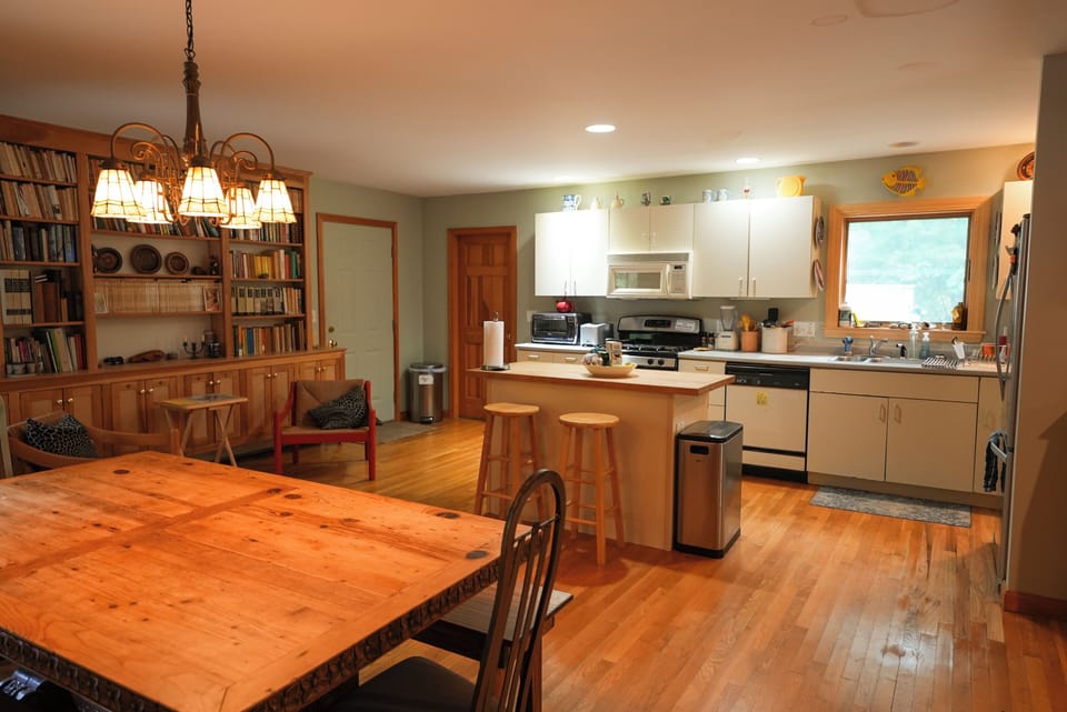 Downstairs open plan with dining area, sitting area, and kitchen featured here. 
