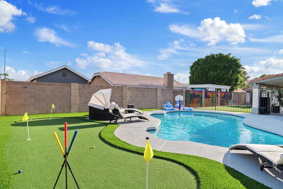 Step into your private oasis where relaxation meets play. Start the day practicing putts on the green, then cool off with a swim in the sparkling pool. Whether lounging in the sun or gathering under the shaded patio, this backyard offers fun and leis