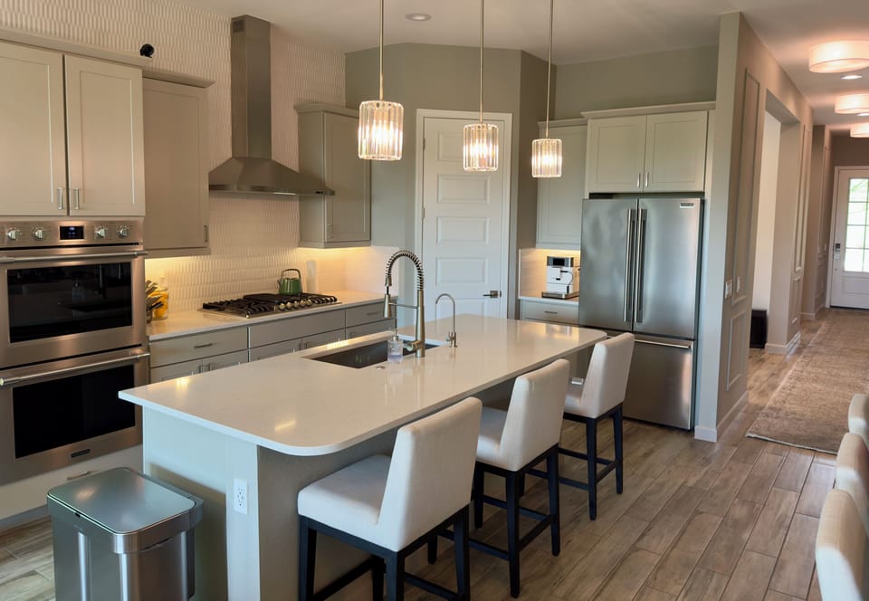Kitchen with coffee bar, double oven, and barstool seating 