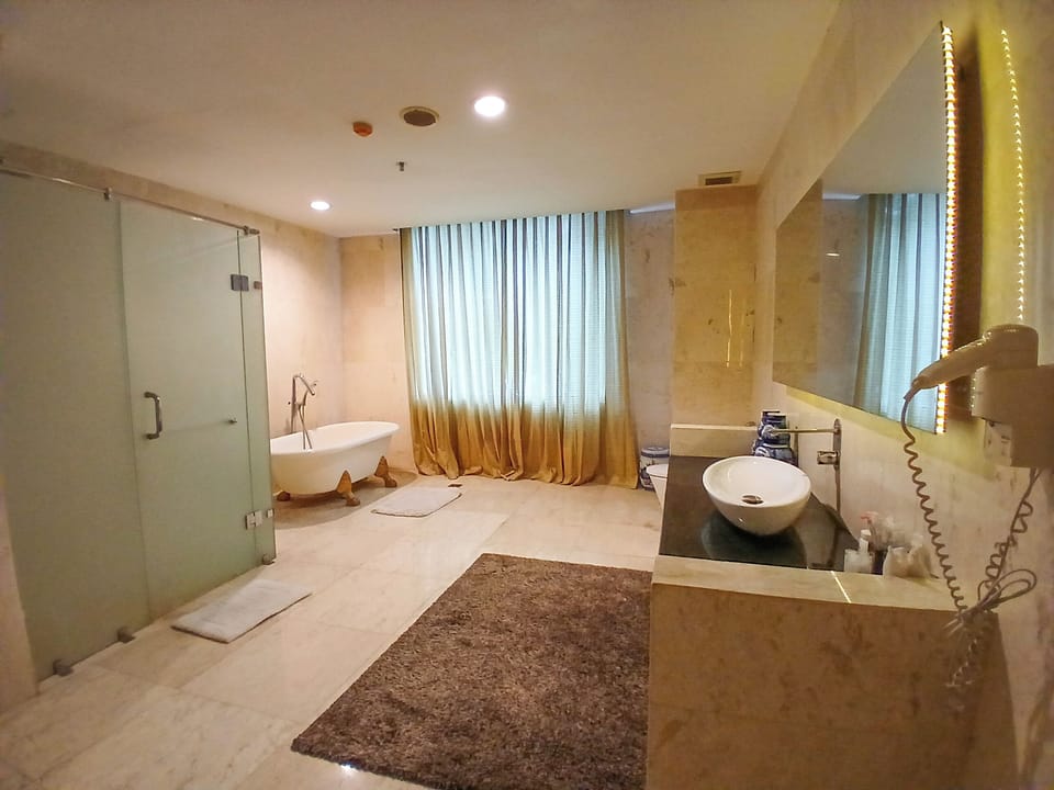 Family Suite, Microwave, City View | Bathroom | Slippers, towels, soap, shampoo