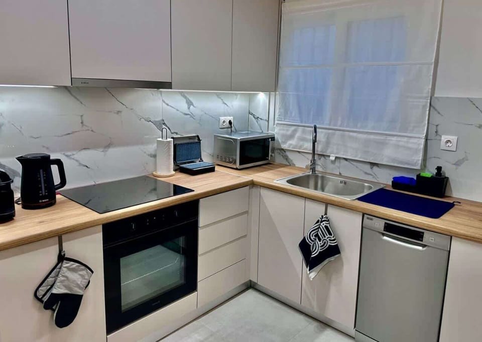Fully equipped modern kitchen designed for convenient meal preparation during extended Athens stays.