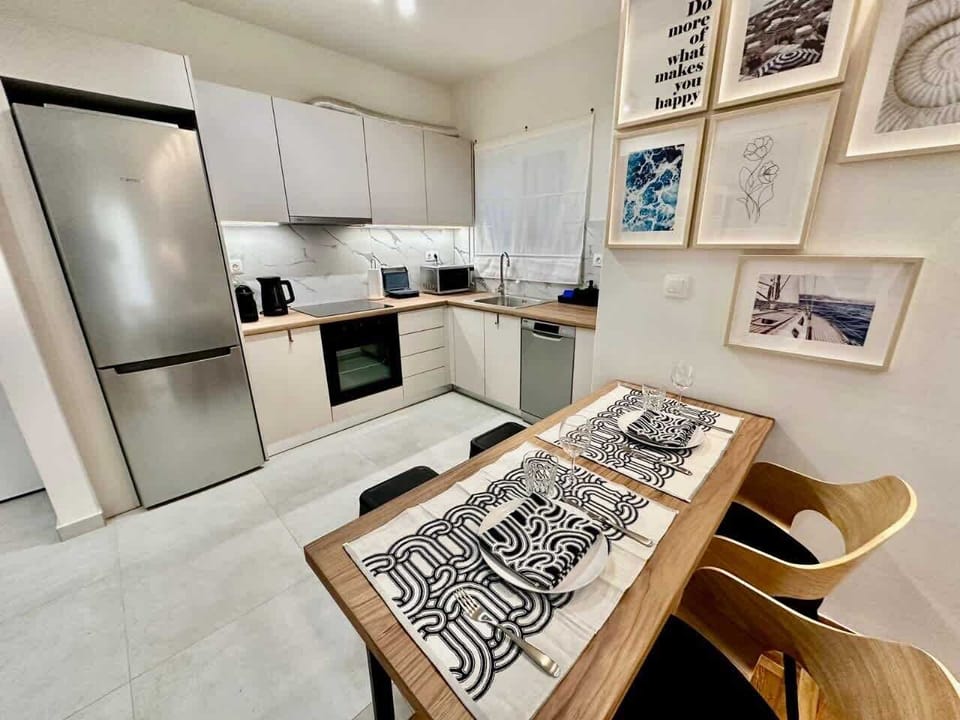Bright modern kitchen with dining table, perfect for easy meals in central Athens.