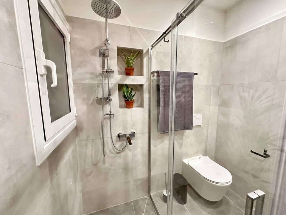 Contemporary bathroom with glass shower, offering a refreshing and well-designed daily routine space.