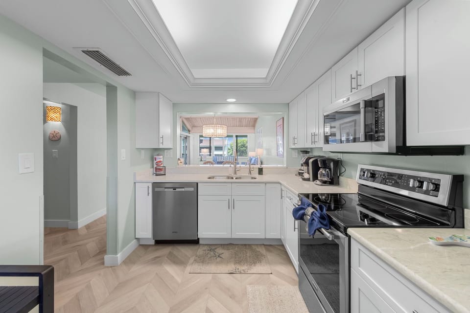Fully equipped kitchen with modern appliances and coastal charm.
