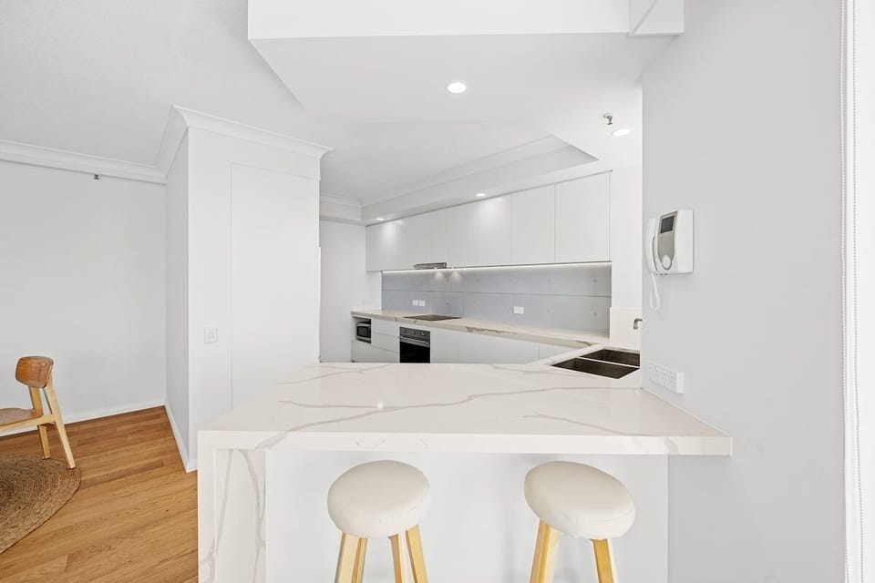 Breakfast bench seating adds a casual spot beside the open-plan kitchen setting.