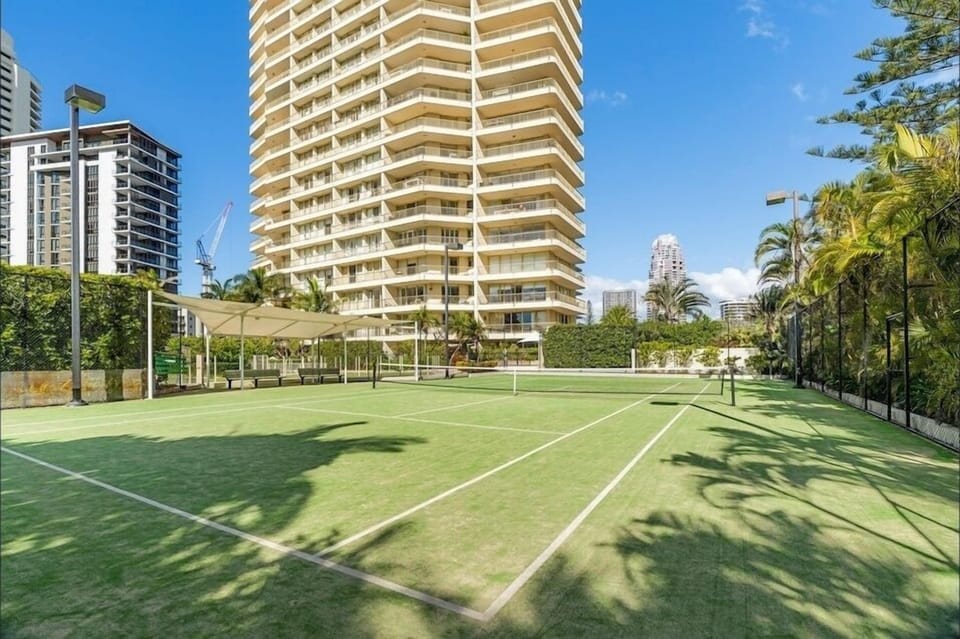 Full-size tennis court sits with the pool, spa, sauna and gym facilities nearby.