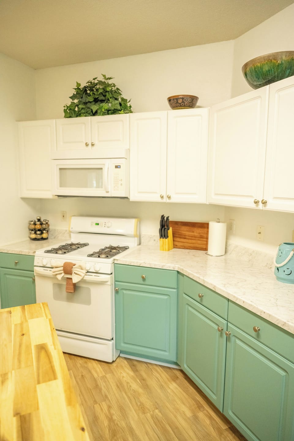 Fully equipped kitchen with a gas range, spice rack and ample counter space