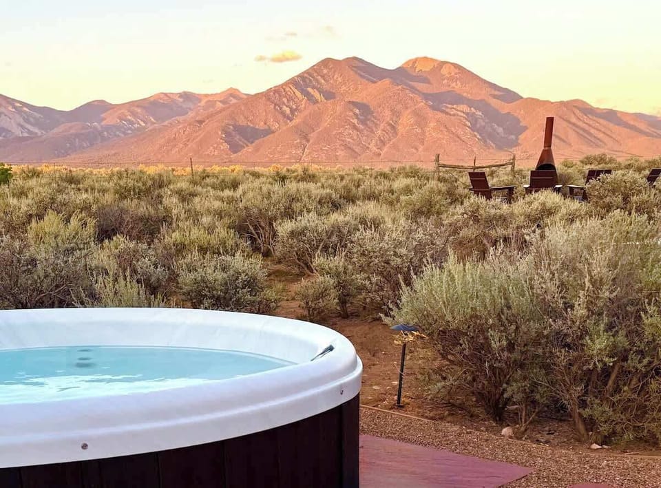 Private hot tub with sweeping views of the Sangre de Cristo Mountains, perfect for unwinding under the Taos sky.