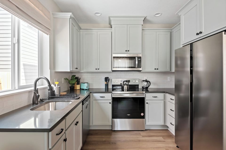 Kitchen with dishwasher, oven, microwave, and fridge
