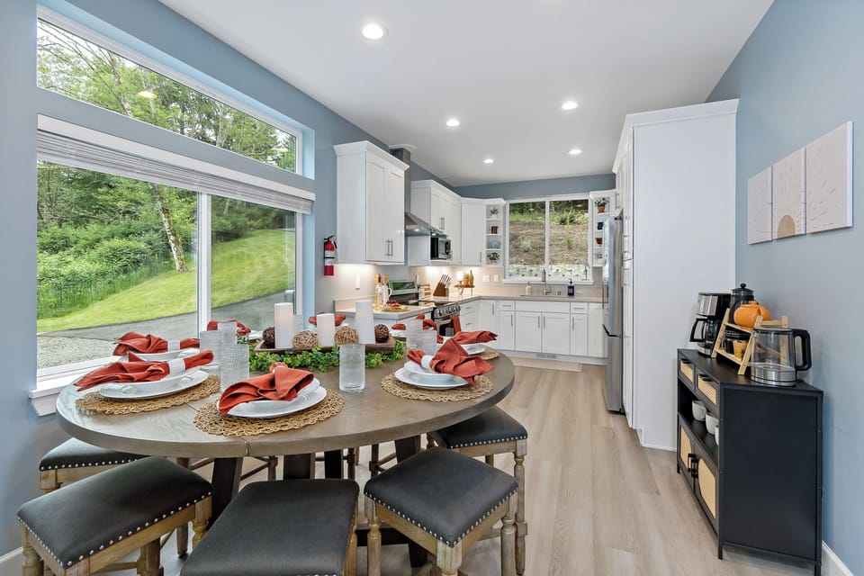 Bright modern kitchen with scenic windows and dining for six