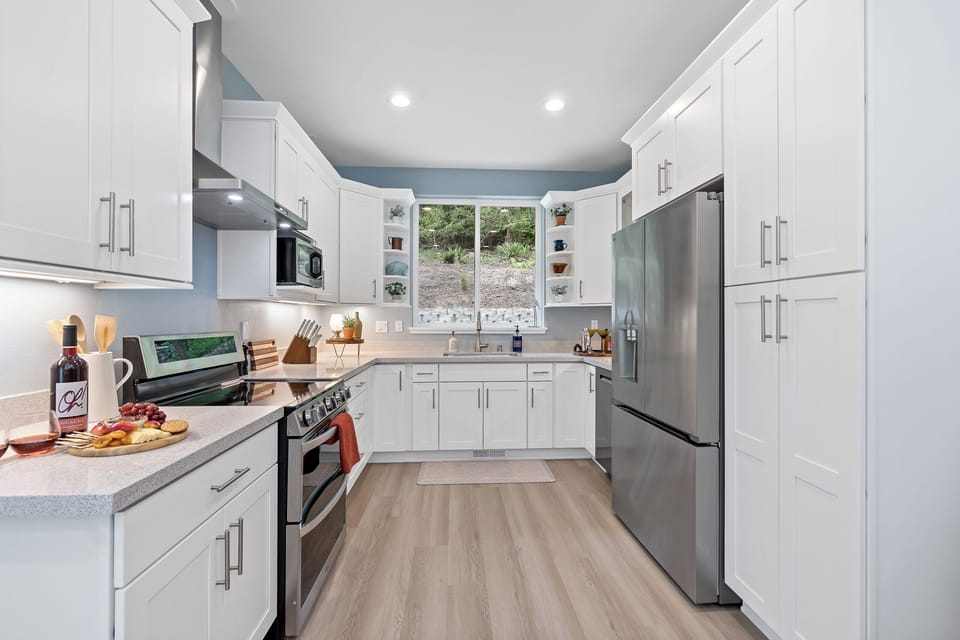 Bright modern kitchen with stainless appliances and scenic window views