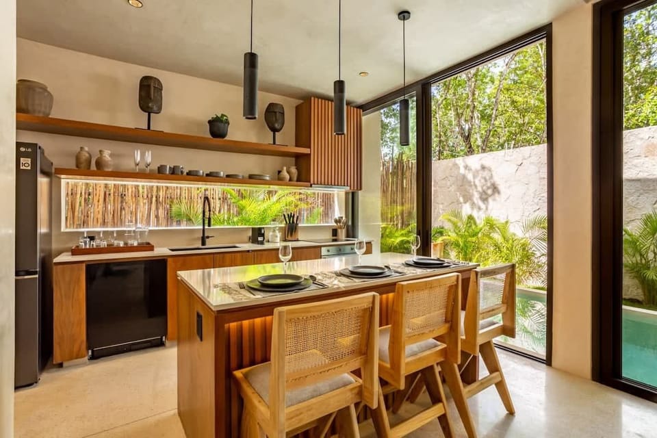 Gather around the breakfast bar, featuring a fully equipped chef kitchen, stainless steel appliances —perfect for leisurely mornings and entertaining evenings. 