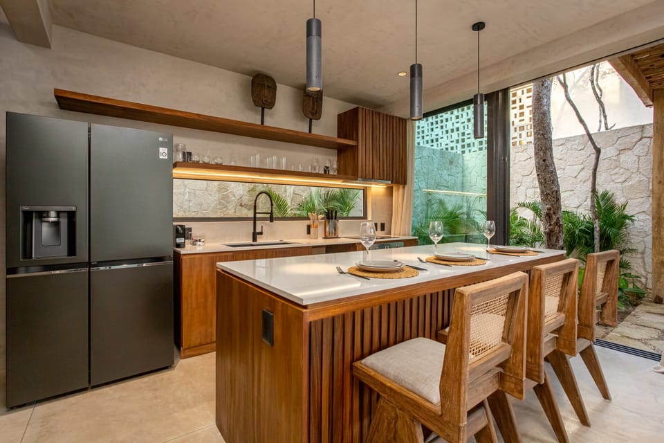 The kitchen features direct access to your private garden, blending indoor comfort with outdoor relaxation.