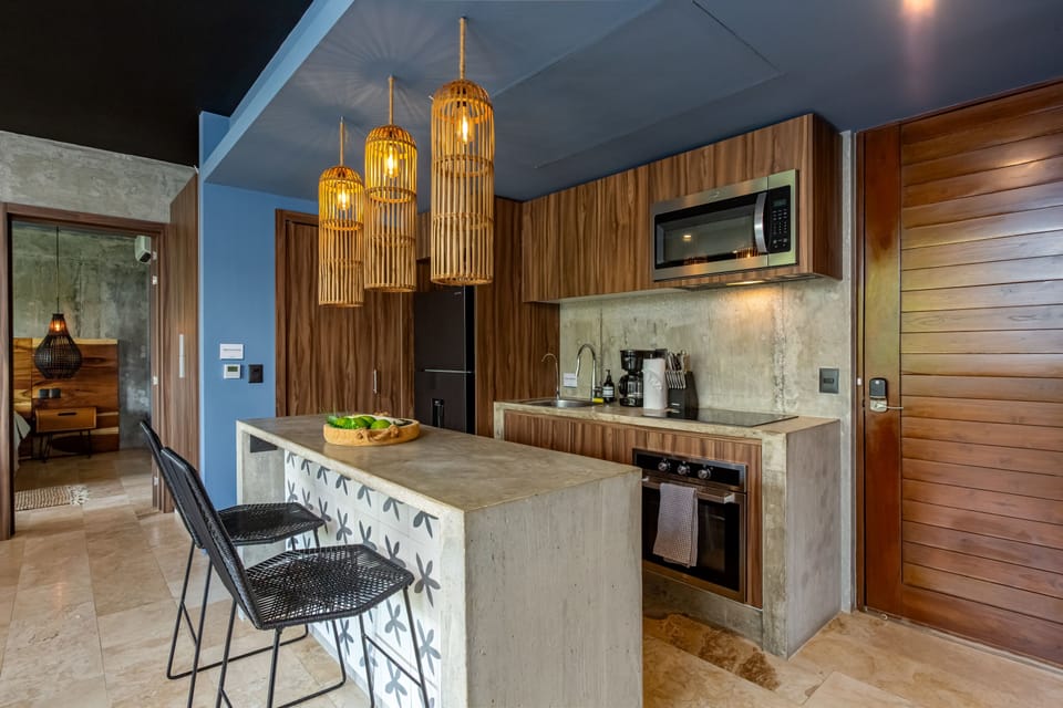 Whip up your favorite dishes in this stylish kitchen, complete with all the essentials: oven, stove, fridge, and microwave