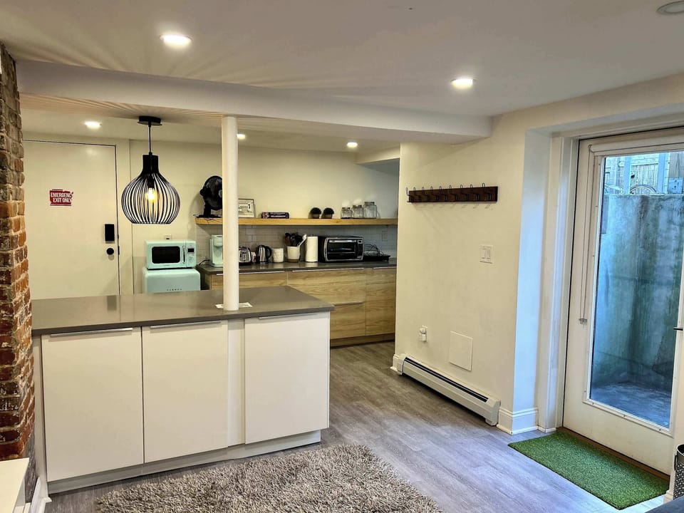 Full size living room with couch, Smart TV, & private entrance 