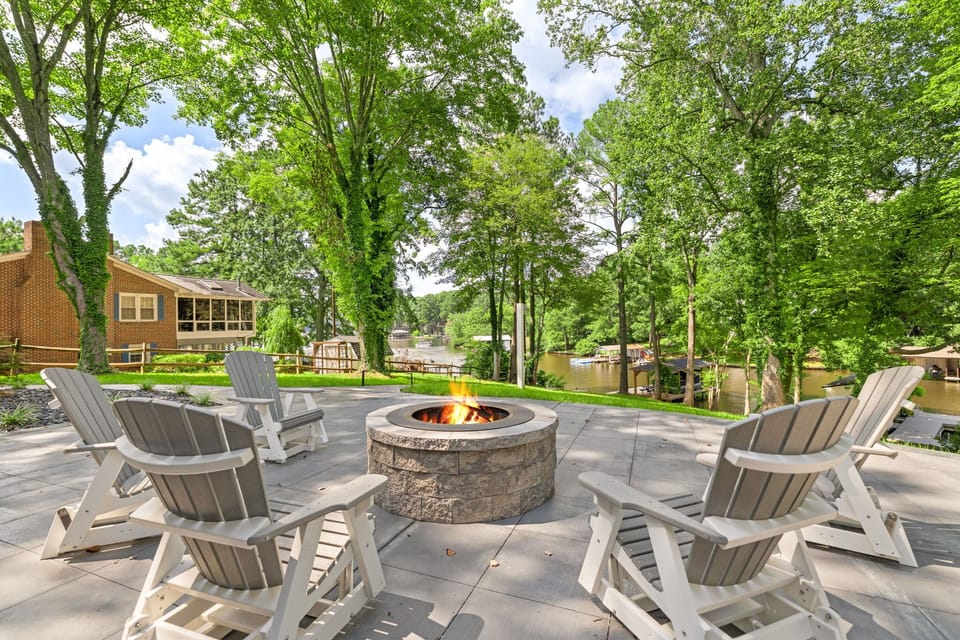 Fire pit with 5 Adirondack rockers for cozy nights.