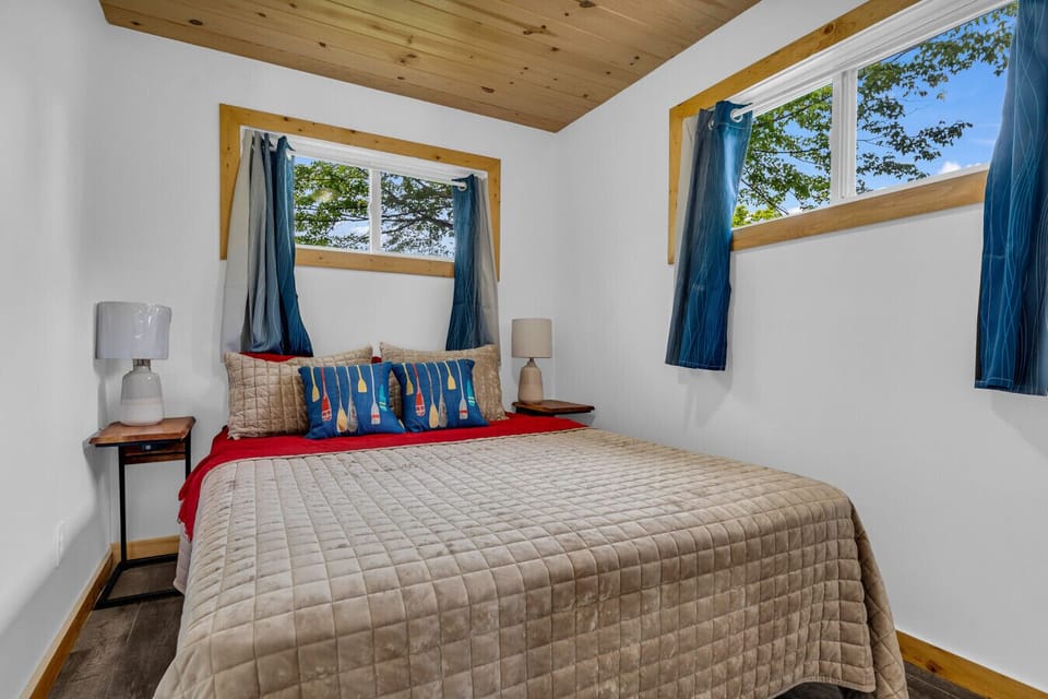 Bedroom with full bed – Rest easy in this bright, welcoming bedroom with a full-size bed and cozy lake-inspired touches.