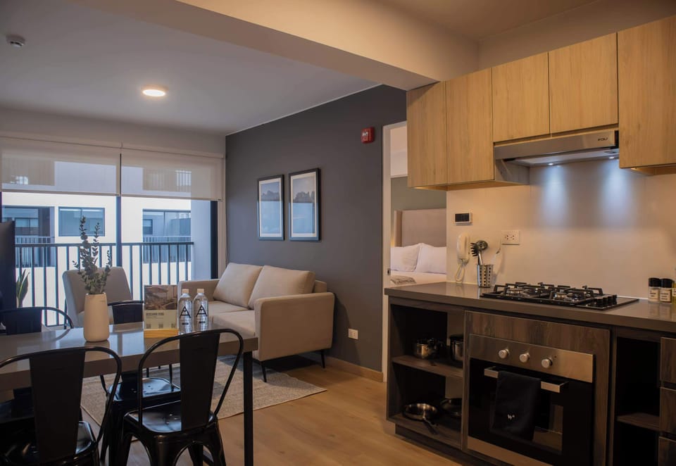 Dining table next to kitchen, connected to living room area.