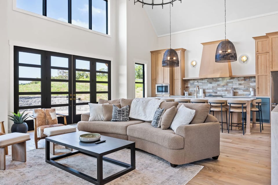 Living Room 1: Imagine cozy evenings spent on this plush sofa, surrounded by natural light and elegant design. This living room is the heart of your home away from home.