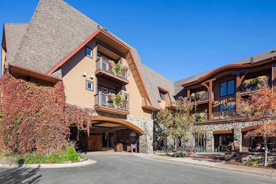 Arrive to a welcoming lodge-style exterior under blue skies.