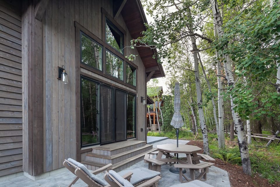 Linger outdoors with forest views, loungers, and picnic dining.